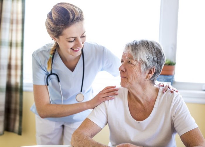 A Senior woman with her caregiver at home